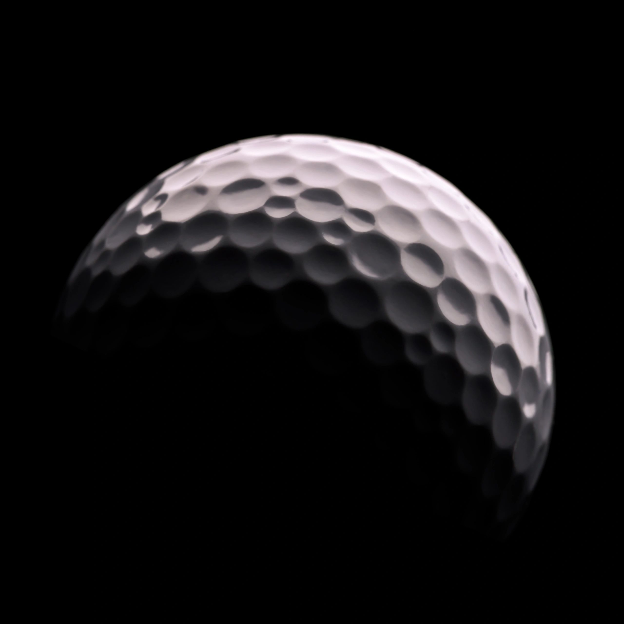 Close-up golf ball on dark background