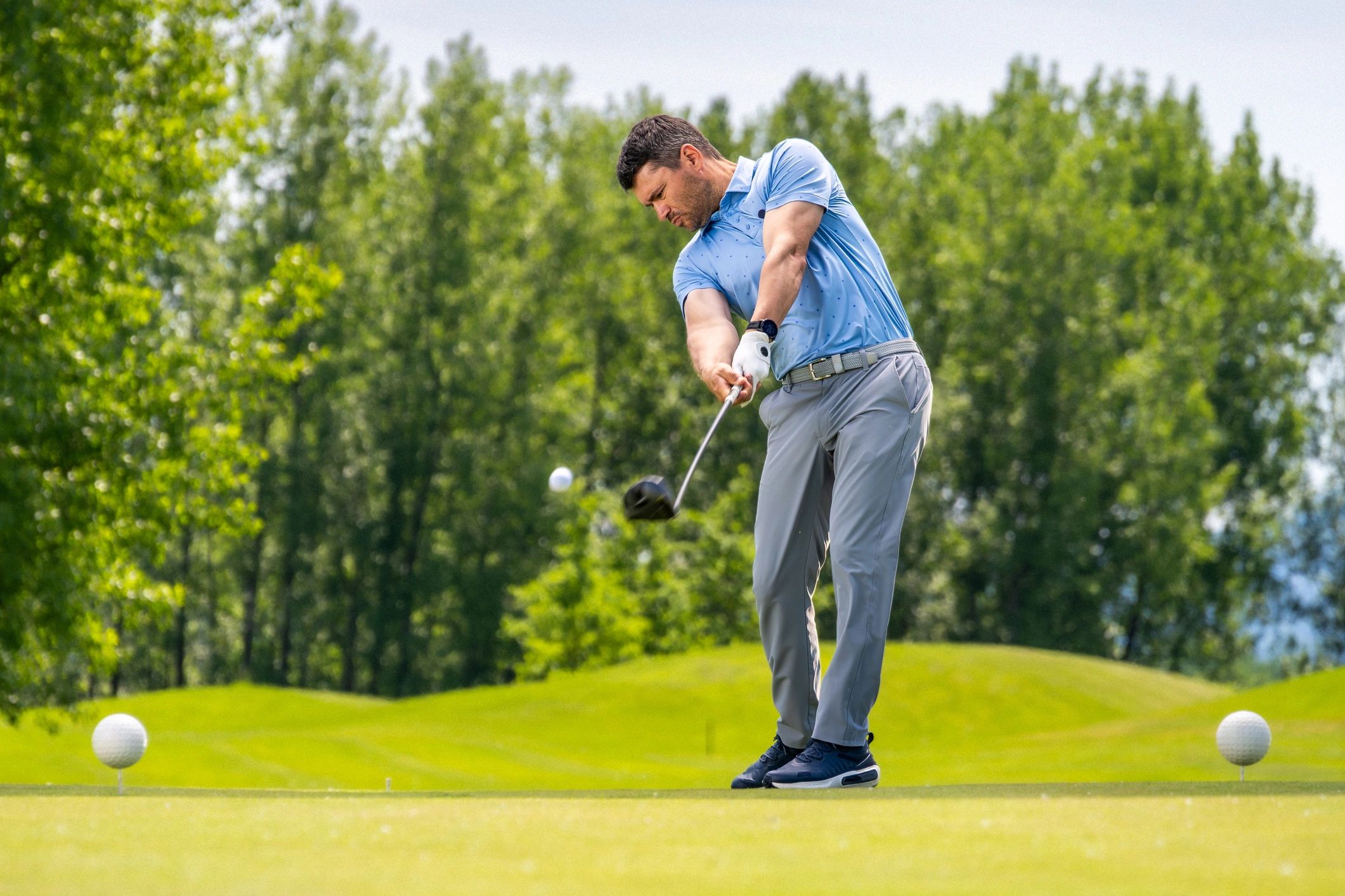 Golfer on a green course preparing a shot